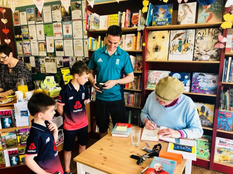 Cricket legend, Henry Blofeld signs books and bats for two young fans!